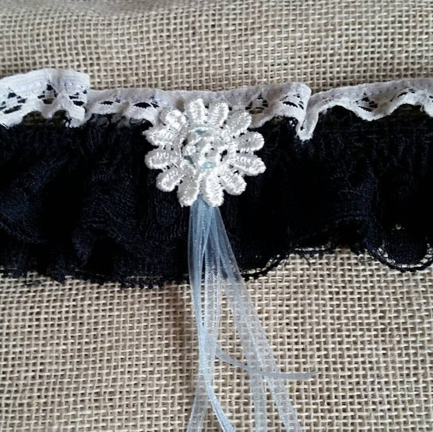 Navy blue lace bridal garter accessory.