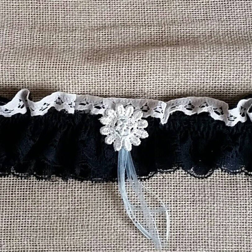 Navy blue lace bridal garter accessory.