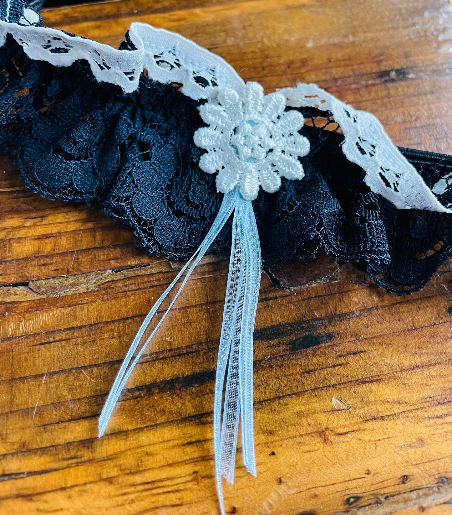 Navy blue lace bridal garter accessory.