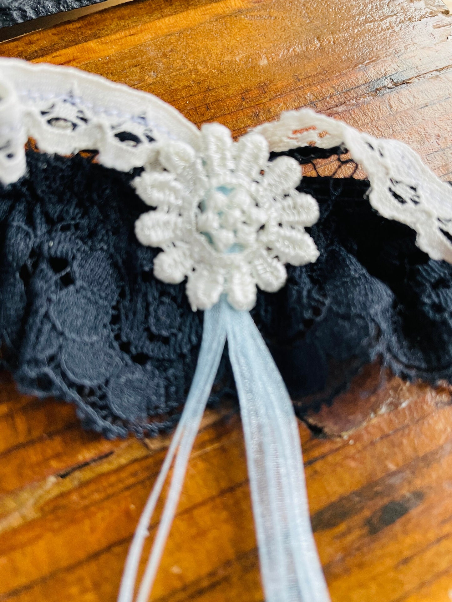 Navy blue lace bridal garter accessory.