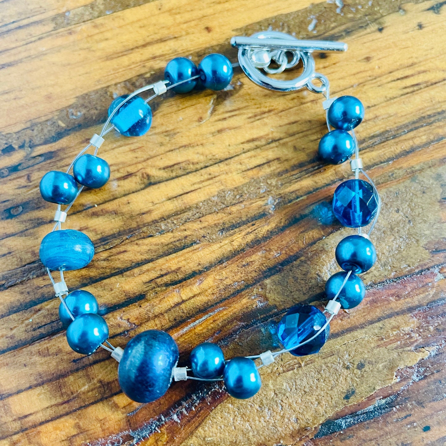 Teal blue beaded bracelet with silver plated toggle clasp.  One of a kind.